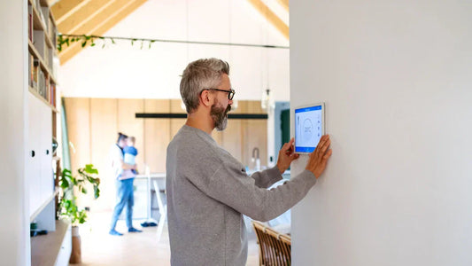 Smart-Home Haftung & Sicherheit: Mann steuert Wand-Display im vernetzten Zuhause.